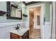 Bathroom featuring a vanity, wainscoting and patterned wall paper at 12 Roberta Rd, Concord, NC 28027