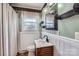 Vintage bathroom featuring a vanity, patterned wall paper and window at 12 Roberta Rd, Concord, NC 28027