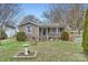 Charming brick home with landscaped front yard and a quaint covered porch entrance at 12 Roberta Rd, Concord, NC 28027