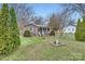 Quaint single-story home with a cozy front porch and manicured landscaping at 12 Roberta Rd, Concord, NC 28027