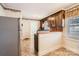 Kitchen with stainless steel refrigerator and view of the adjoining laundry area at 12 Roberta Rd, Concord, NC 28027