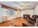 Bright living room with hardwood floors, vintage piano, and comfortable seating area at 12 Roberta Rd, Concord, NC 28027