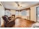 Spacious living room with hardwood floors, fireplace, and natural light from large windows at 12 Roberta Rd, Concord, NC 28027