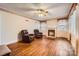 Open living room featuring hardwood floors, a cozy fireplace, and classic decorative trim at 12 Roberta Rd, Concord, NC 28027