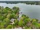 Beautiful aerial view of lakeside home surrounded by mature trees, showcasing a tranquil and private setting with water access at 121 Kelly Point Ln, Mooresville, NC 28117