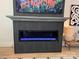 Modern fireplace with a black tiled facade, sleek design, and contemporary art above it at 121 Kelly Point Ln, Mooresville, NC 28117