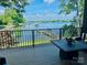 Relaxing deck view overlooking the lake with docks, boats, and lush greenery at 121 Kelly Point Ln, Mooresville, NC 28117