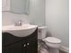 Bathroom featuring a dark vanity and white toilet at 12432 Bradford Park Dr, Davidson, NC 28036