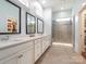 Bathroom featuring a glass-enclosed shower and double sinks at 12432 Bradford Park Dr, Davidson, NC 28036