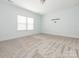 Well lit bedroom with soft carpet and a large window at 12432 Bradford Park Dr, Davidson, NC 28036