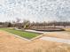 Community playground and recreation area featuring swings, slides, and a bocce court at 12432 Bradford Park Dr, Davidson, NC 28036