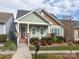 Charming home featuring a welcoming front porch, manicured landscaping, and a well-maintained lawn at 12432 Bradford Park Dr, Davidson, NC 28036