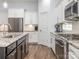 Modern kitchen with white cabinets, granite countertops, and stainless steel appliances at 12432 Bradford Park Dr, Davidson, NC 28036