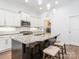 Bright kitchen featuring a granite island with seating, white cabinets, and modern stainless steel appliances at 12432 Bradford Park Dr, Davidson, NC 28036