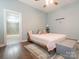 Serene main bedroom featuring a ceiling fan, a window with natural light, and an ensuite bathroom at 12432 Bradford Park Dr, Davidson, NC 28036