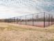 Outdoor tennis courts, fenced in, with people playing under a cloudy sky at 12432 Bradford Park Dr, Davidson, NC 28036