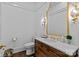 Bathroom featuring a wood vanity with a marble countertop and decorative lighting at 1414 Biltmore Dr, Charlotte, NC 28207