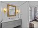 Bathroom with a vintage mirror, decorative vanity with marble countertop, and sconce lighting at 1414 Biltmore Dr, Charlotte, NC 28207