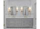 Bathroom featuring a double sink vanity with marble countertop and decorative lighting at 1414 Biltmore Dr, Charlotte, NC 28207