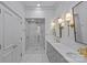 Elegant bathroom featuring marble tiling, gold fixtures, double vanity, and a glass-enclosed shower at 1414 Biltmore Dr, Charlotte, NC 28207