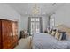 Bright bedroom with a chandelier, ample natural light, wardrobe, and seating area at 1414 Biltmore Dr, Charlotte, NC 28207