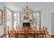 Elegant dining room featuring a chandelier, fireplace, and large windows providing natural light at 1414 Biltmore Dr, Charlotte, NC 28207