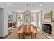 Bright dining room features a fireplace, chandelier, and large table ideal for hosting gatherings at 1414 Biltmore Dr, Charlotte, NC 28207