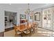 Dining area boasts a chandelier, hardwood floors, and ample natural light from the large windows at 1414 Biltmore Dr, Charlotte, NC 28207