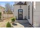 A sophisticated front entrance featuring a dark-colored door flanked by decorative stone statues and manicured landscaping at 1414 Biltmore Dr, Charlotte, NC 28207