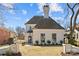 An elegant, light-colored stone home with a slate roof, and a well-manicured gravel front yard and gate at 1414 Biltmore Dr, Charlotte, NC 28207