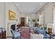 A sunlit living room with a classic fireplace, elegant furniture, and large windows at 1414 Biltmore Dr, Charlotte, NC 28207