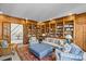 Cozy living room with a fireplace, wood paneling, and large bookshelves creating a library feel at 1414 Biltmore Dr, Charlotte, NC 28207