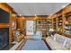 Spacious living room with wood paneled walls, fireplace, built-in bookshelves, and comfortable seating at 1414 Biltmore Dr, Charlotte, NC 28207