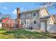 Rear exterior view showcasing the deck, chimney, well-maintained siding and yard at 1417 Shady Bark Dr, Gastonia, NC 28054