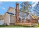 Back exterior features a large deck, brick chimney, and a lush green lawn at 1417 Shady Bark Dr, Gastonia, NC 28054