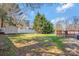 Large backyard featuring a shed, a wooden deck, green trees, and a well-maintained lawn at 1417 Shady Bark Dr, Gastonia, NC 28054