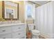 Bright bathroom with a marble vanity, decorative mirror, and a neutral color scheme at 1417 Shady Bark Dr, Gastonia, NC 28054