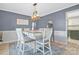 A stylish dining room is displayed with a modern chandelier, elegant decor, and comfortable seating for six at 1417 Shady Bark Dr, Gastonia, NC 28054