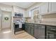 Well-lit kitchen featuring granite countertops, stainless steel appliances, and dark green and white cabinets at 1417 Shady Bark Dr, Gastonia, NC 28054