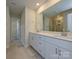 Bathroom featuring double sink vanity, a large mirror and a glass-enclosed shower at 146 Aberdeen Dr, Salisbury, NC 28144