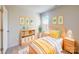 Cheerful bedroom with a bed, a yellow blanket, and a toy shelf for a  at 146 Aberdeen Dr, Salisbury, NC 28144