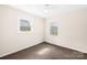 This bedroom is bright with two windows, neutral walls, and carpet flooring at 1502 Northwoods Dr, Kings Mountain, NC 28086