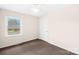 This bedroom features neutral walls, carpet flooring, and a large window at 1502 Northwoods Dr, Kings Mountain, NC 28086