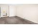 This bedroom features neutral walls and carpet flooring, alongside a door opening to another room at 1502 Northwoods Dr, Kings Mountain, NC 28086