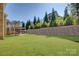 Large backyard with green grass, beautiful greenery, and a wonderful patio area at 17809 Pawleys Plantation Ln, Charlotte, NC 28278