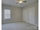 Bedroom with neutral carpeting, two white doors and modern ceiling fan at 17809 Pawleys Plantation Ln, Charlotte, NC 28278