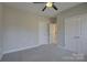 Neutral bedroom with modern ceiling fan, carpeting and white base trim molding at 17809 Pawleys Plantation Ln, Charlotte, NC 28278