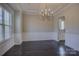 Well-lit dining room with a decorative chandelier, large window, and wainscoting at 17809 Pawleys Plantation Ln, Charlotte, NC 28278