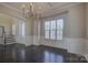 Elegant dining room featuring a chandelier, hardwood floors, and wainscoting at 17809 Pawleys Plantation Ln, Charlotte, NC 28278