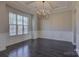 Dining room features a chandelier, a large window, and decorative wainscoting at 17809 Pawleys Plantation Ln, Charlotte, NC 28278